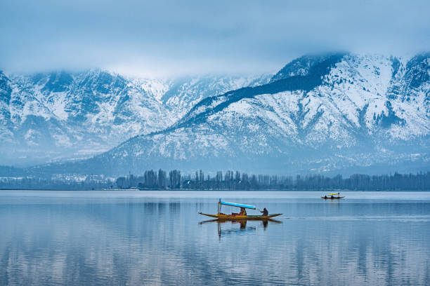 A view of Dal Lake in winter, and the beautiful mountain range in the background in the city of Srinagar, Kashmir, India.